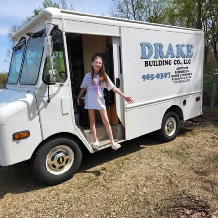 girl standing in ice cream truck before the truck was repainted